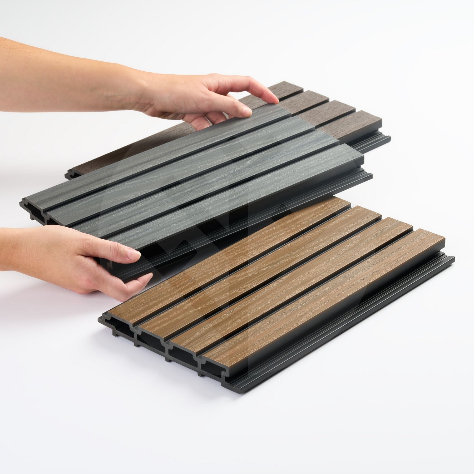 Close-up of Plaank oak sample piece showing realistic wood-effect composite grain texture