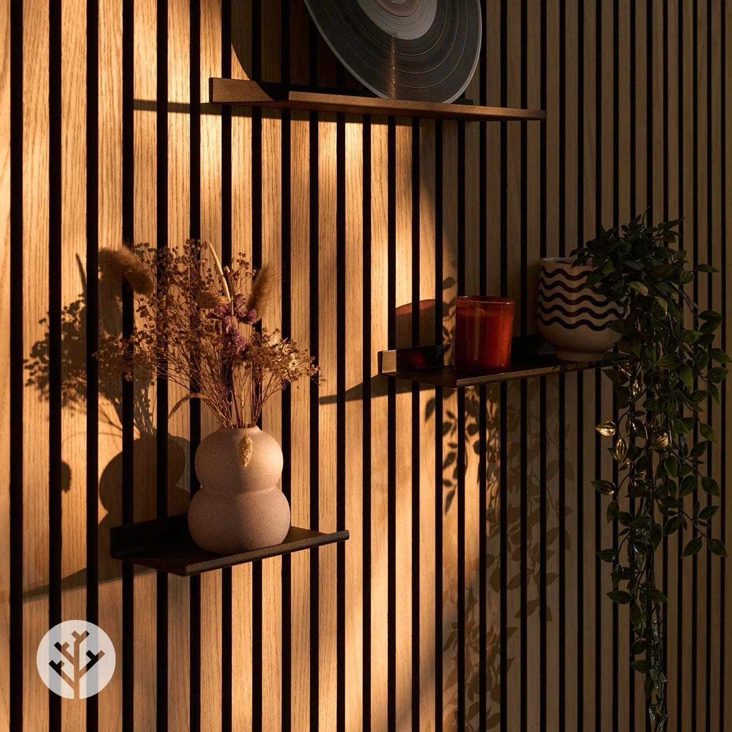 Hand placing decorative item on large ledge shelf demonstrating easy styling on Acupanel wall