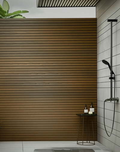 Modern home exterior with Plaank oak composite slat panels as warm-toned facade cladding