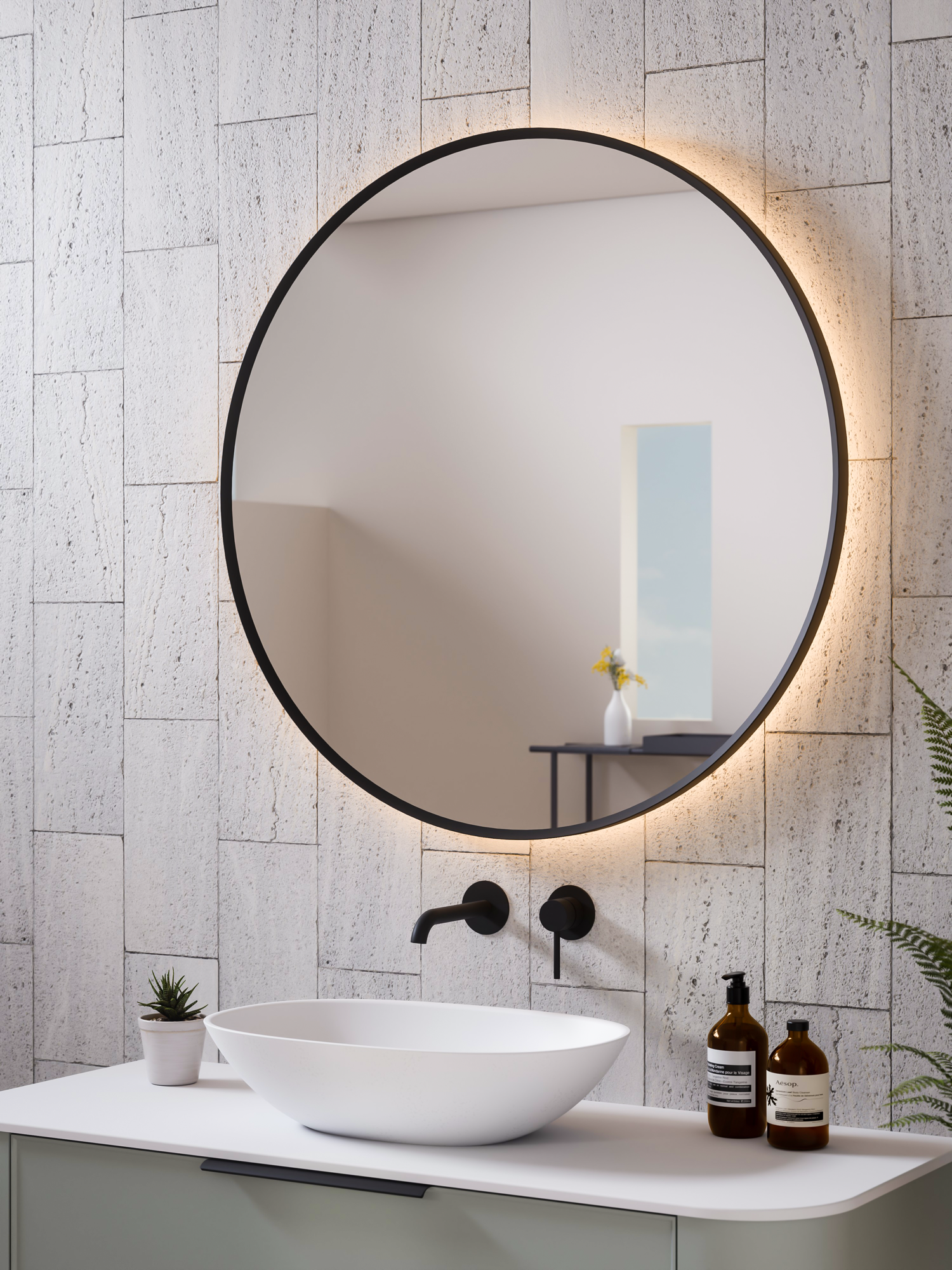 Close-up of Aura round mirror black frame showing curved brushed metal and LED edge glow