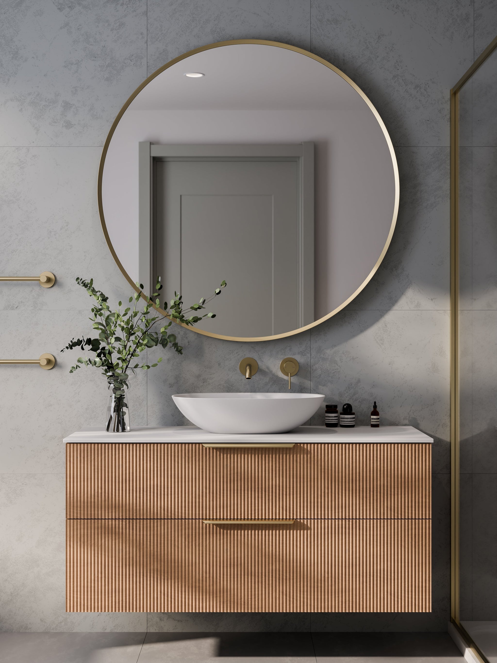 Aura round mirror with LED backlight in dimly lit bathroom creating warm ambient glow
