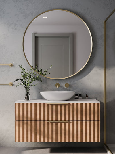 Aura round mirror with LED backlight in dimly lit bathroom creating warm ambient glow