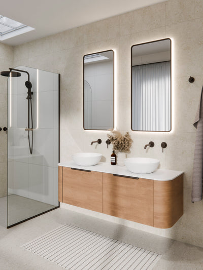 Close-up of Aura mirror black frame corner showing brushed metal finish and LED edge glow
