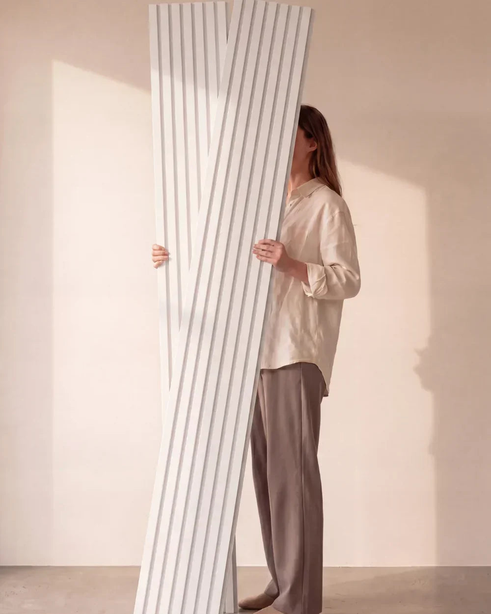 Acupanel White acoustic slat wall panels held in studio