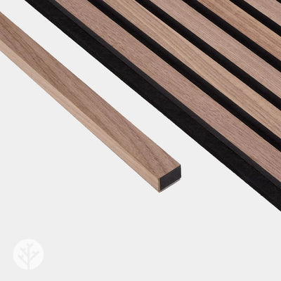 Bundle of Acupanel walnut end piece trims showing consistent dark wood grain across pieces