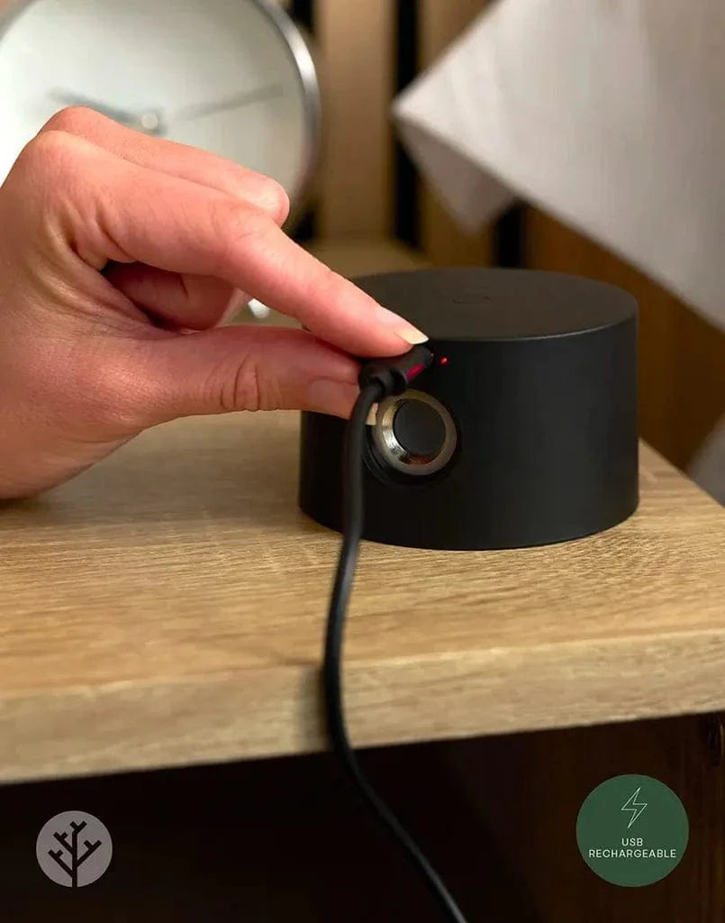 Close-up of Glow beam light USB charging port on base of black cylindrical housing