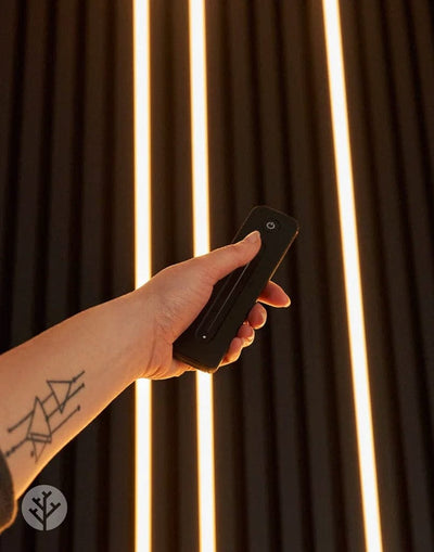 Acupanel Glow LED remote control alongside light strip showing compatible pairing setup