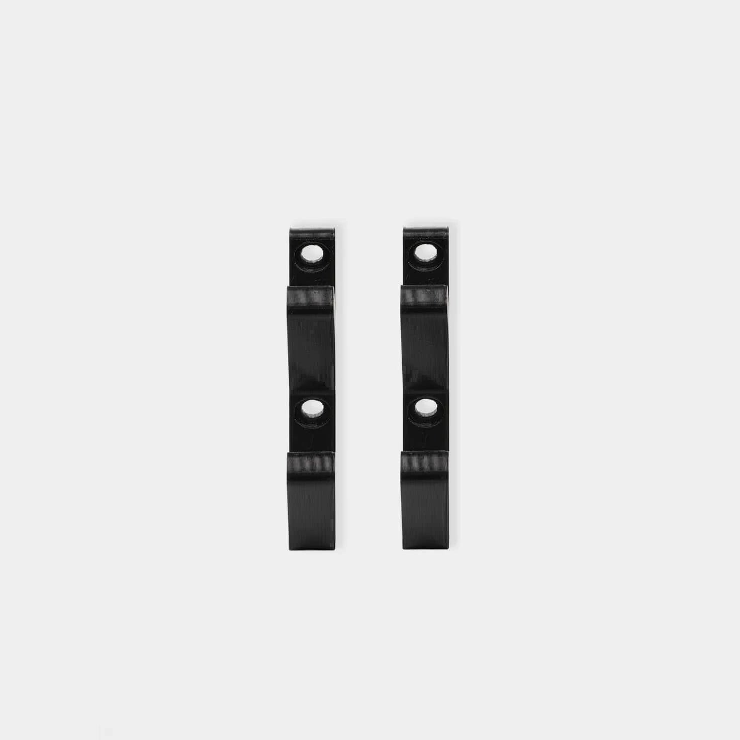 Pair of black 3D hooks flat lay on white background showing mounting bracket design