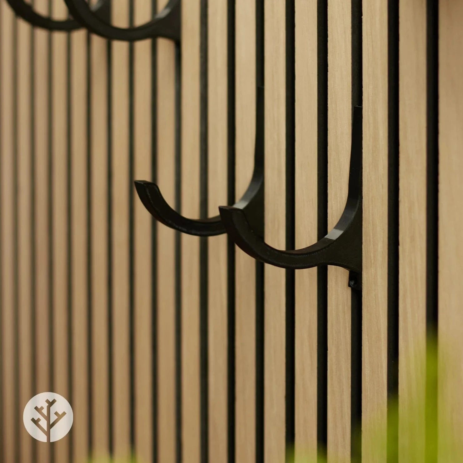 Side view of black wine rack showing curved bracket profile that cradles wine bottle securely