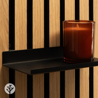Small ledge shelf on oak Acupanel holding candle and small decorative objects in styled vignette
