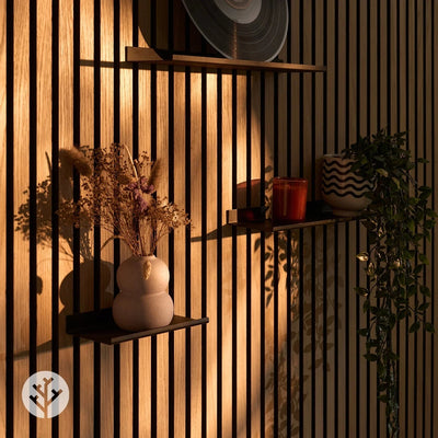 Hand placing decorative item on large ledge shelf demonstrating easy styling on Acupanel wall