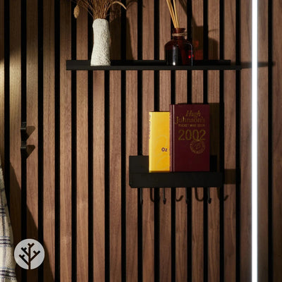 Shelf with hooks installed on oak Acupanel wall in entryway holding bags keys and jacket