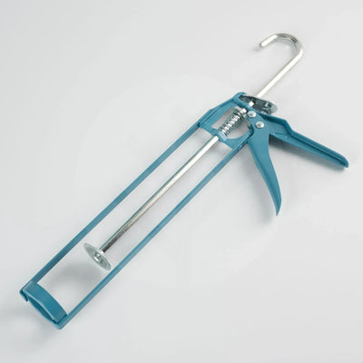 WVH caulking gun being used to apply adhesive to back of Acupanel slat panel for installation