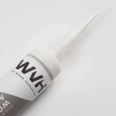 WVH branded white wood panelling adhesive tube with pointed nozzle on white background